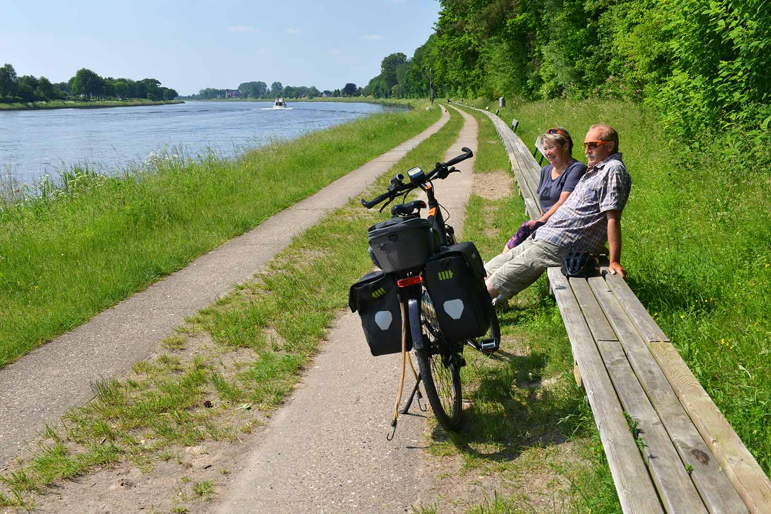 Paar sitzt auf der längsten Bank der Welt am Nord-Ostsee-Kanal